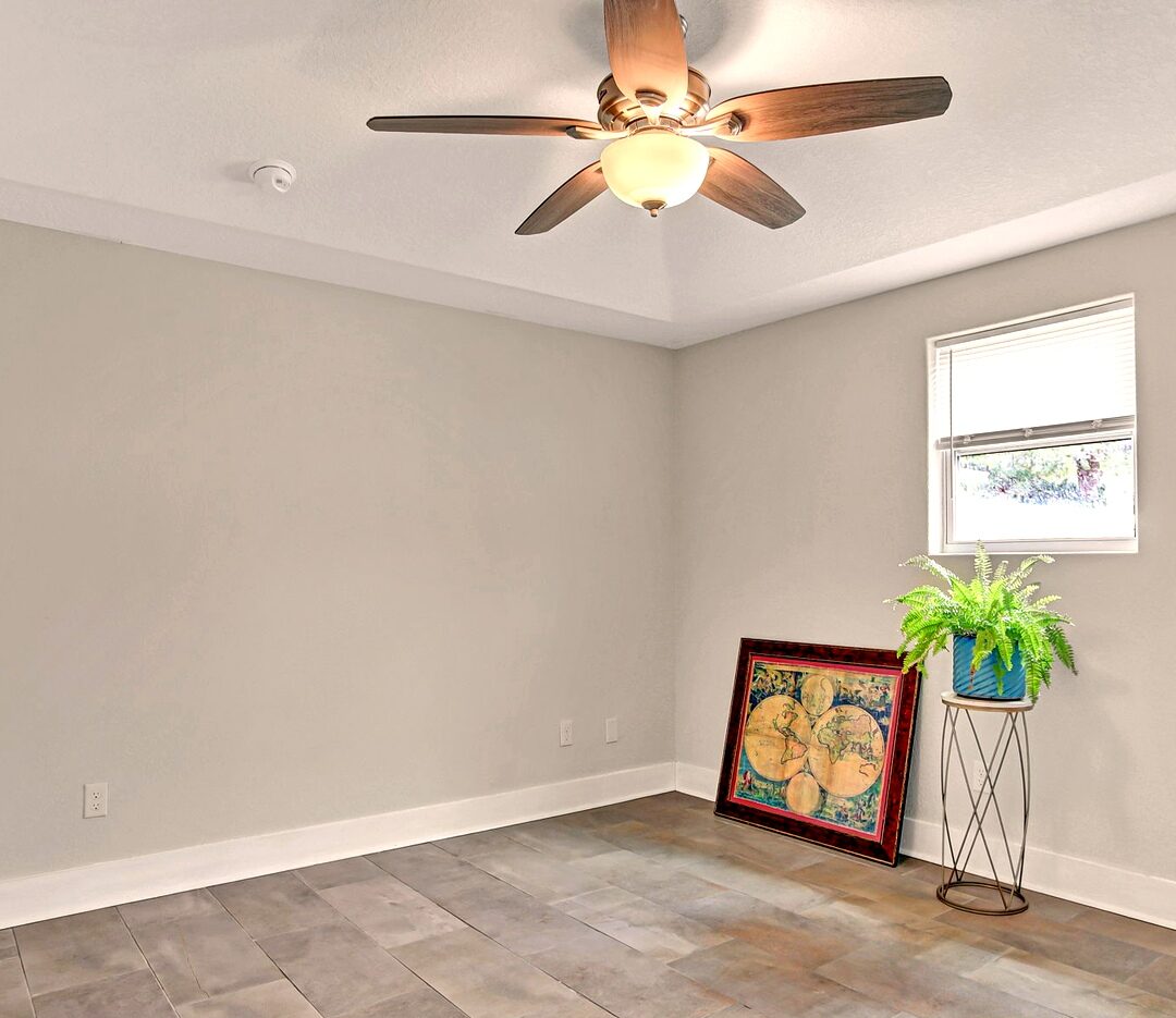 Bedroom with tile flooring, ceiling fan, and window